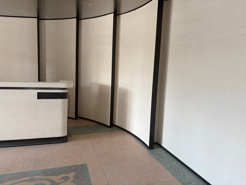Curved cast stone reception desk with black fin dividers