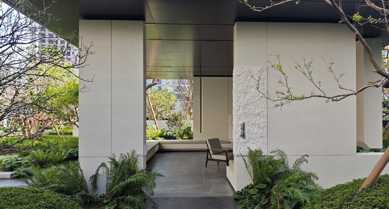 White travertine-clad courtyard with planting and a still water channel